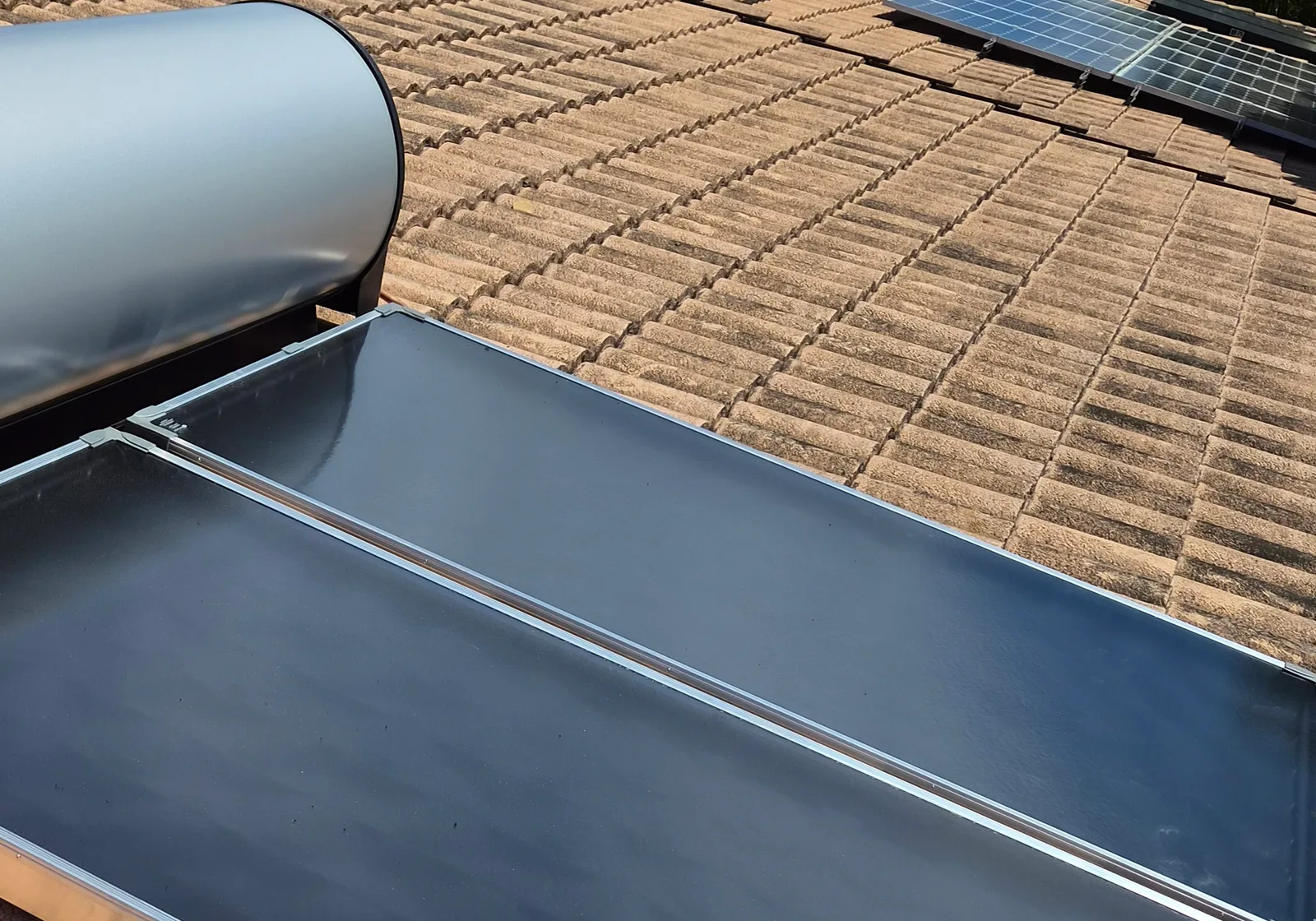 Flat plate solar collectors and the copper flow line on a roof installation by RCM