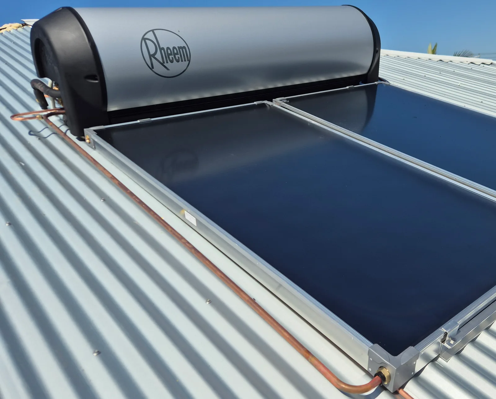 A Rheem solar hot water system installed by RCM on a corrugated iron roof, collectors and tank in place