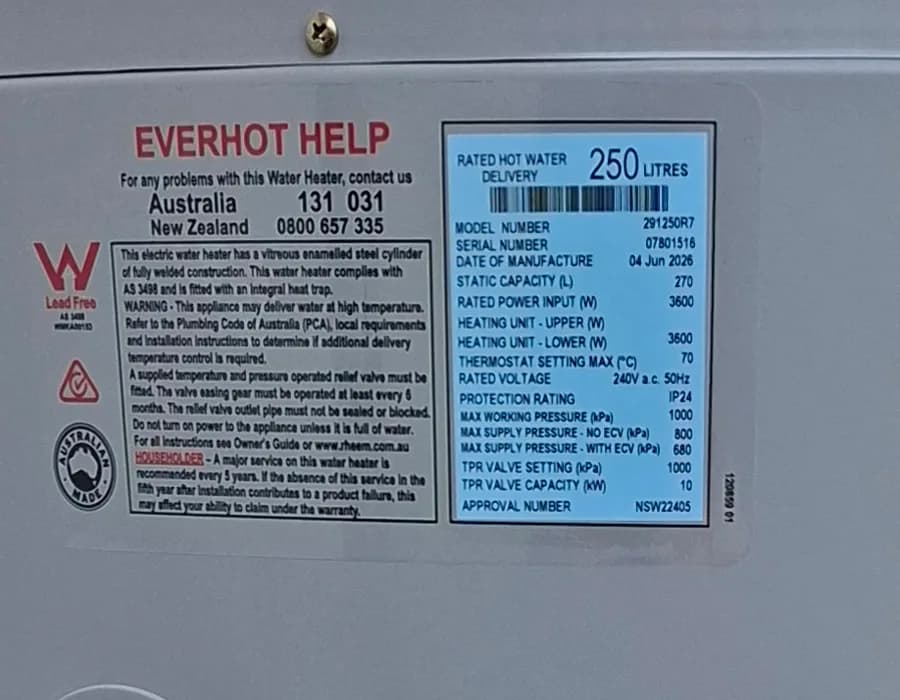 The data plate on a hot water storage tank, showing model, serial number and capacity