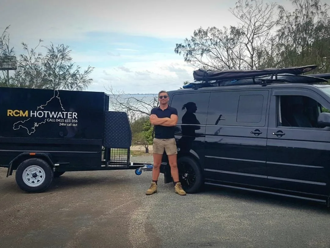 Richard from RCM Hot Water beside the branded work van on the Sunshine Coast