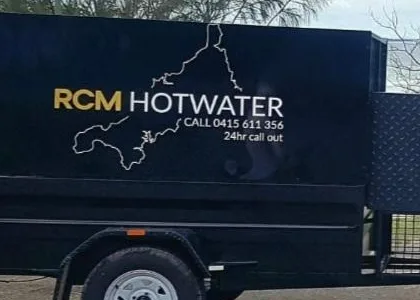 The RCM Hot Water trailer, lettered with the business name, phone number and 24 hour call out